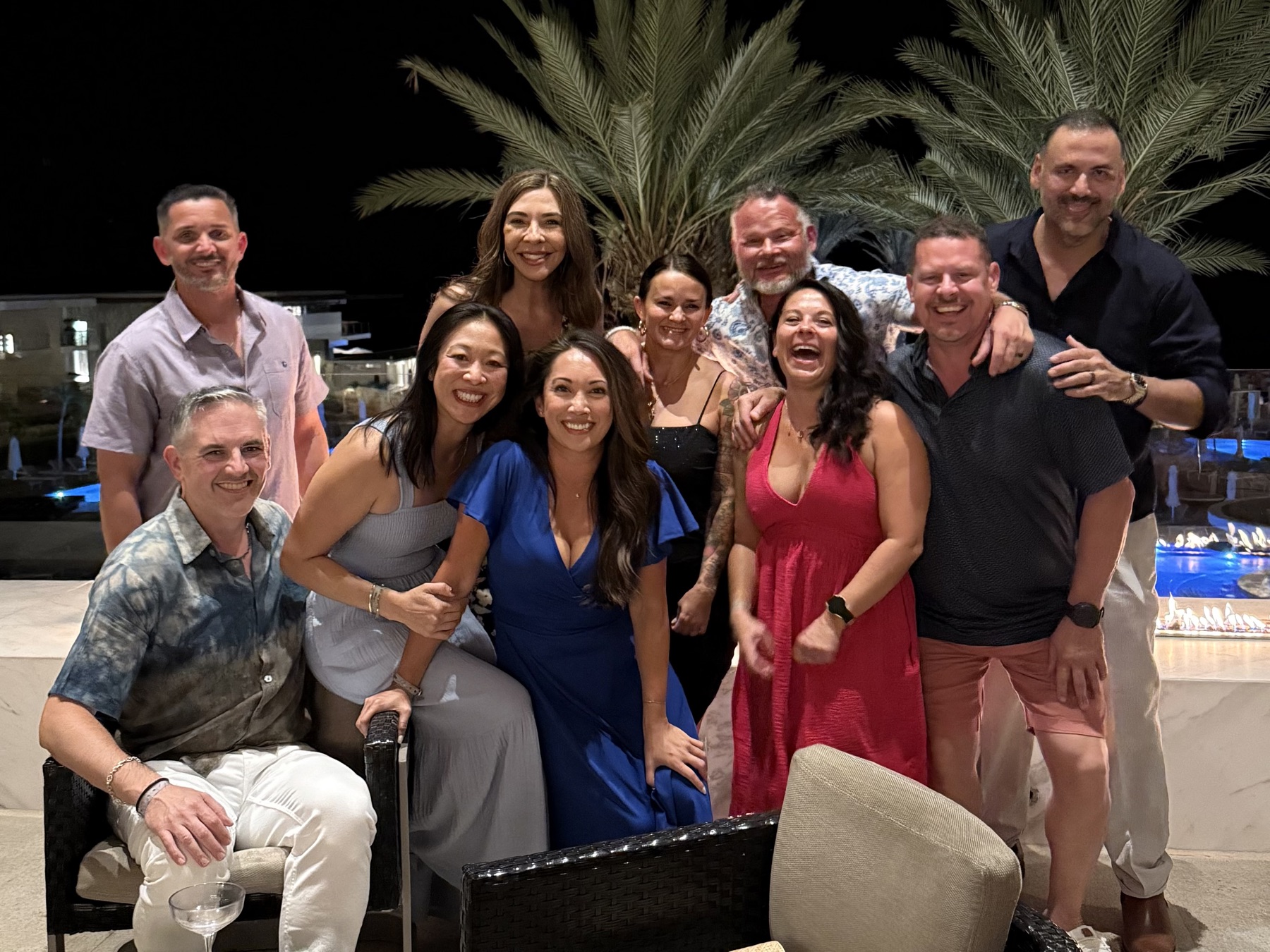 Friends gathered poolside at night